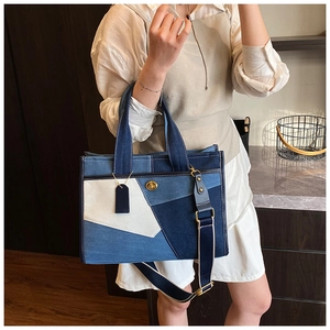 Detail of blue patchwork denim tote bag featuring gold twist lock and wide shoulder strap