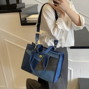 Detailed patchwork denim canvas tote bag with adjustable shoulder strap and metal buckle