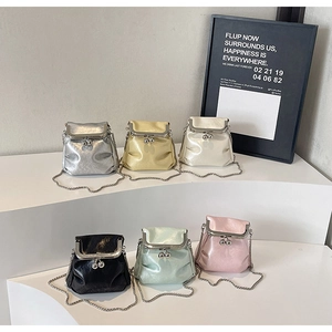 Detailed view of six mini pleated metallic chain bags in various colors on display