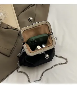 Internal view of black vintage bag showing space for a smartphone and lipsticks