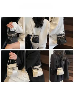 Detailed views of pleated chain crossbody bag in black and cream on a model