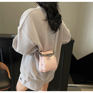 Pink PU leather mini bucket bag with vintage gold clasp and delicate chain strap details