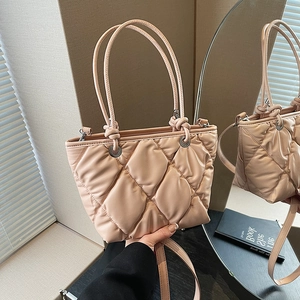 Chic beige quilted cloud tote bag with dual handles and adjustable shoulder strap