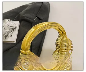 Close-up of the stylish gold knot handle and wavy textured surface on a shell bag