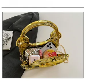 Gold shell clutch bag interior showing space for phone, lipstick and essentials