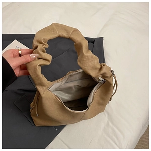 Detailed top view of the ruched handle and textured leather interior of the shoulder bag