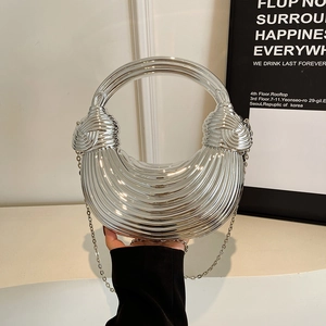 Chic silver acrylic shell bag with striped texture and round handle on chain strap