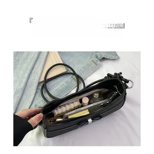 Spacious interior of black leather shoulder bag with zipper pocket for daily essentials