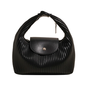 Minimalist black pleated handbag with smooth flap and silver button in a crescent shape