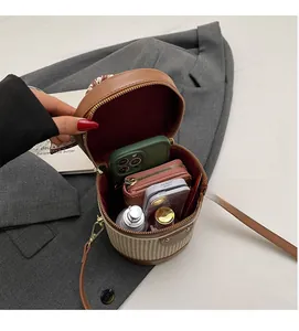 Top view showing spacious interior of woven bucket bag with phone and wallet