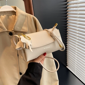 Cream lychee leather crossbody bag with fashion lettering and gold ring hardware detail