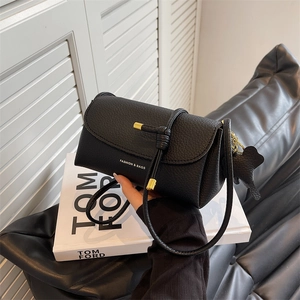 Black pebbled leather crossbody bag with metal drawstring and cute bear pendant charm