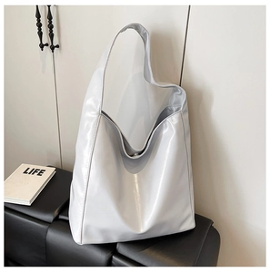 Close-up of metallic silver bucket bag showing soft crinkled texture and glossy finish