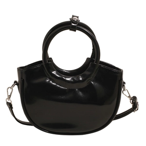 Minimalist black patent leather saddle bag with silver hardware and circular top handles