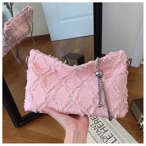 Pink denim shoulder bag with quilted pattern, frayed fringe edges and silver chain strap
