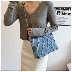 Detail of blue denim crossbody bag with diamond fringe and adjustable chain strap