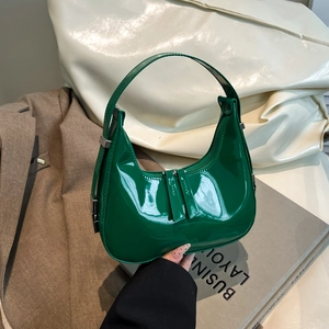 Elegant emerald green patent leather crescent hobo bag with glossy finish and silver hardware