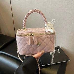 Pink quilted mini suitcase crossbody bag with metal rose lock and lace bow detail
