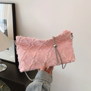 Pink denim underarm bag with quilted frayed edges and adjustable silver chain strap