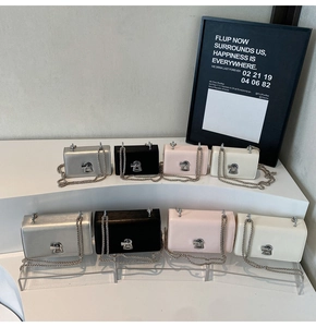 Detailed view of square chain bags in two sizes and four colors with unique twist locks