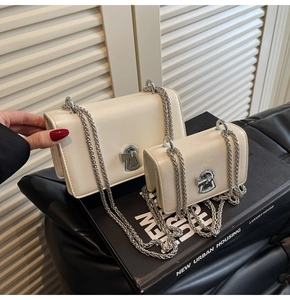 Detail view of two off-white chain bags in different sizes with silver rotating clasps