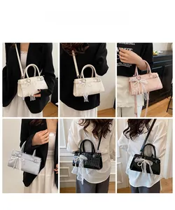 Detailed views of faux crocodile leather handbags with lace bows and pearl charms