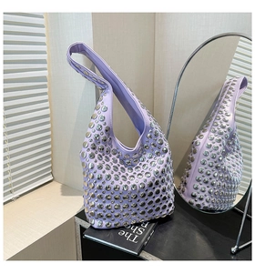 Detail of lavender hobo bag with polished silver rivets on a minimalist background