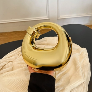 Modern gold mirror finish acrylic box clutch with sculptural cutout and beaded chain strap