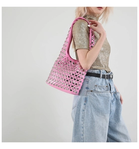 Detail of pink Y2K shoulder bag with decorative silver rivets and smooth leather finish
