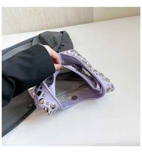 Close-up of purple punk underarm bag interior with silver studs and magnetic buckle