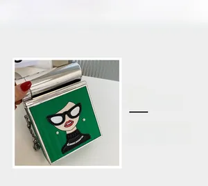 Detailed view of pop art portrait print on green square bag with silver metal latch