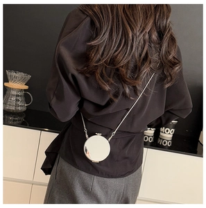 Detailed view of mini silver mirror acrylic crossbody bag with metal chain strap