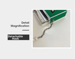 Detail magnification showing detachable clasp on chain strap with pearls and metal