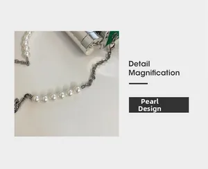 Detail magnification of the silver metal chain and round white pearl design