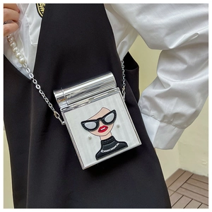 Detail of silver flap square bag featuring a cartoon woman print and pearl chain strap