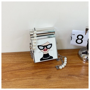 Detail of creative square bag with Karl-style cartoon embroidery and pearl chain strap