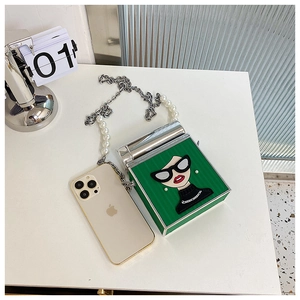 Detail of vintage green square box bag with cartoon face and pearl chain strap