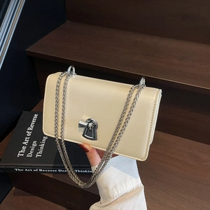 Chic cream white crossbody flap bag with silver keyhole lock and chain strap
