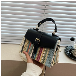 Detail of colorful V-shaped straw weave texture with black leather flap and metal clasp