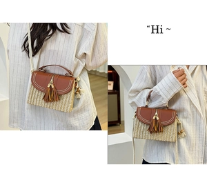 Detail of woven straw crossbody bag featuring brown leather flap and stylish dual tassels