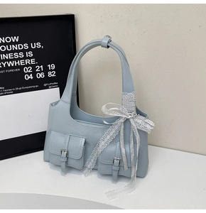 Light blue matte shoulder bag with bow, lace details and twin front metal buckle pockets