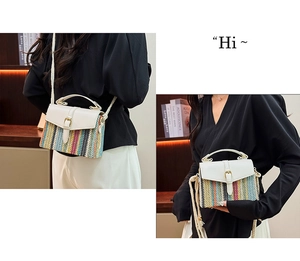 Detail of bohemian striped straw bag with white leather flap and tassel shoulder strap