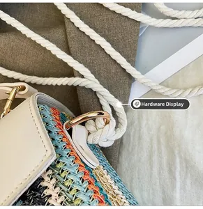 Close-up of golden D-ring hardware and textured woven fabric on a beach bag