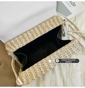 Close-up of woven straw bag with white leather flap and spacious interior lining
