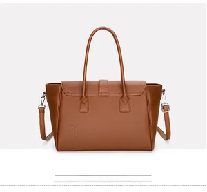 Detail of brown litchi pattern leather tote bag with silver hardware and handle