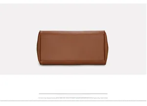 Detail view of the brown lychee pattern leather base with reinforced stitching craft