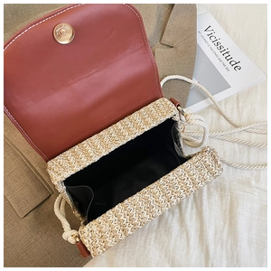 Detail of straw crossbody bag with leather flap, magnetic closure and cotton rope strap