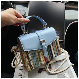 Detail of blue leather and rainbow woven straw bag with thick cotton rope strap