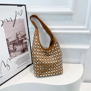 Retro tan leather underarm bag with silver rivet studs and a stylish crescent shape