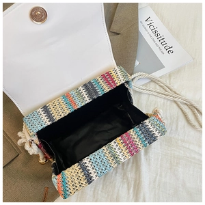 Macro detail of color-blocked woven bag with magnetic clasp and woven cotton shoulder strap